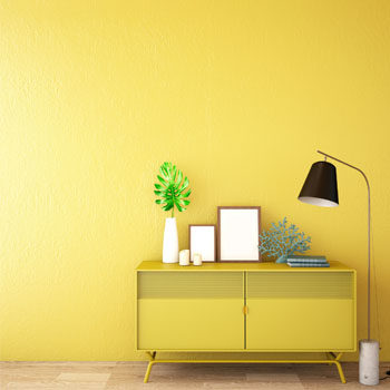 yellow dresser against yellow wall