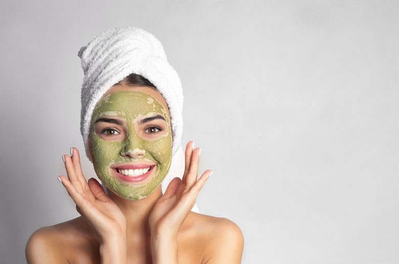 woman applying avocado natural face mask