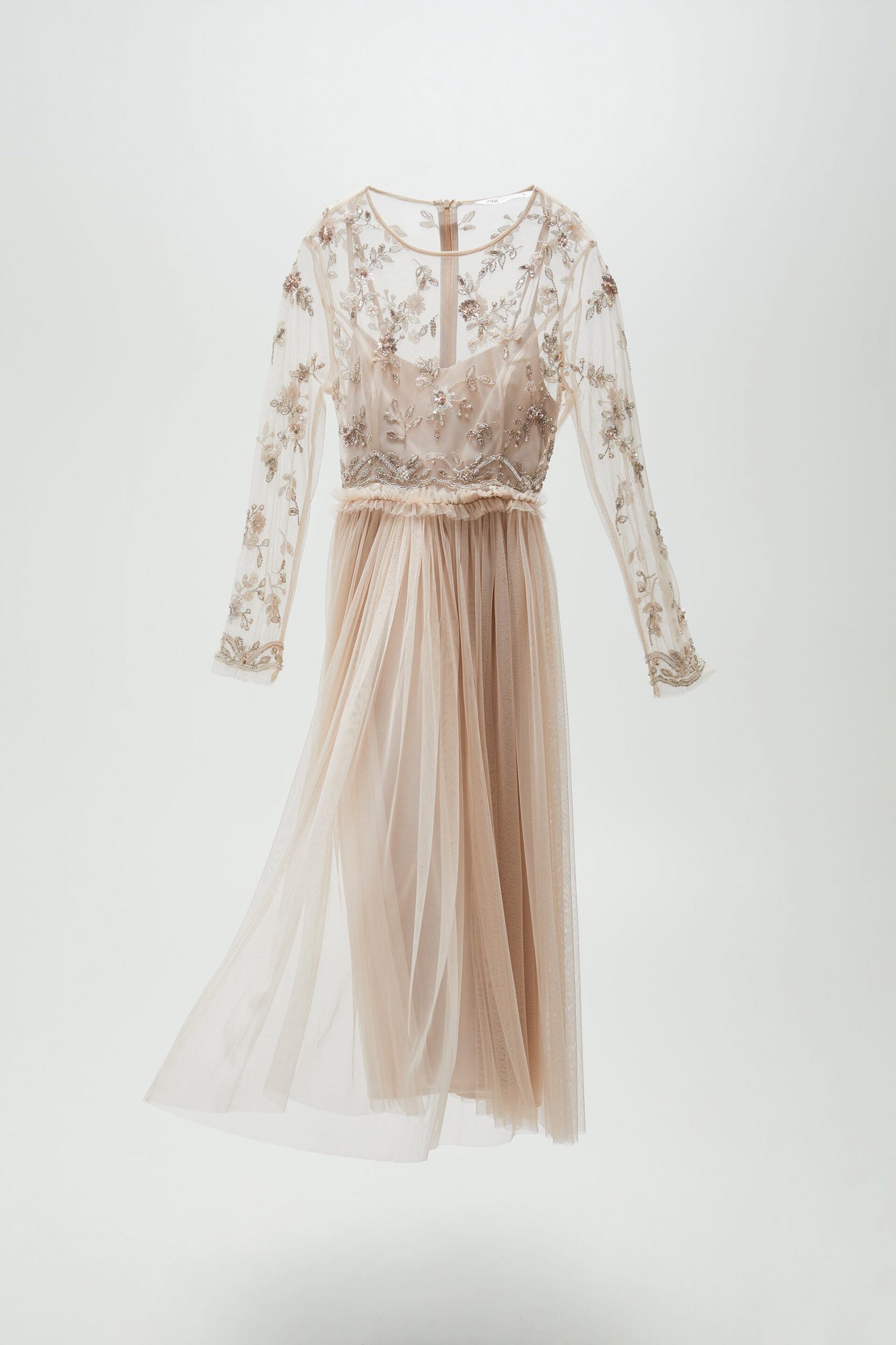 Light pink full-length dress with tulle skirt and beaded top with full-length sleeves