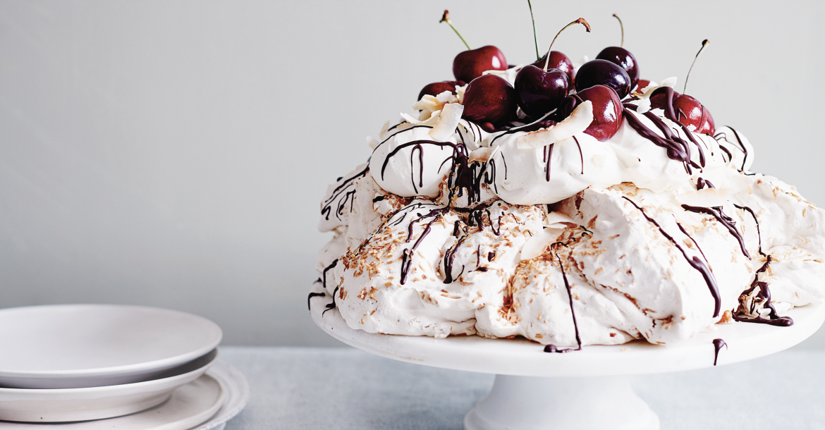 Coconut pavlova with chocolate swirl cream & cherries
