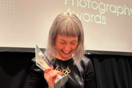 Lee Ann Olwage holding the Sony World Photography Award 2023