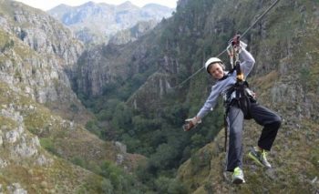 a kid smiling while ziplining