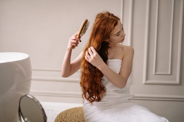 oily hair woman brushing hair
