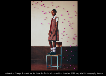 school girl standing on a chair