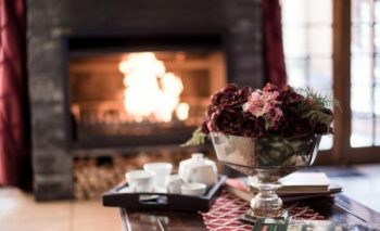 a fireplace with some coffee on a tray