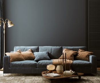 a dark coloured couch against a dark wall