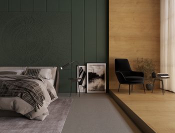 a dark green headboard and a light grey bed in front of it