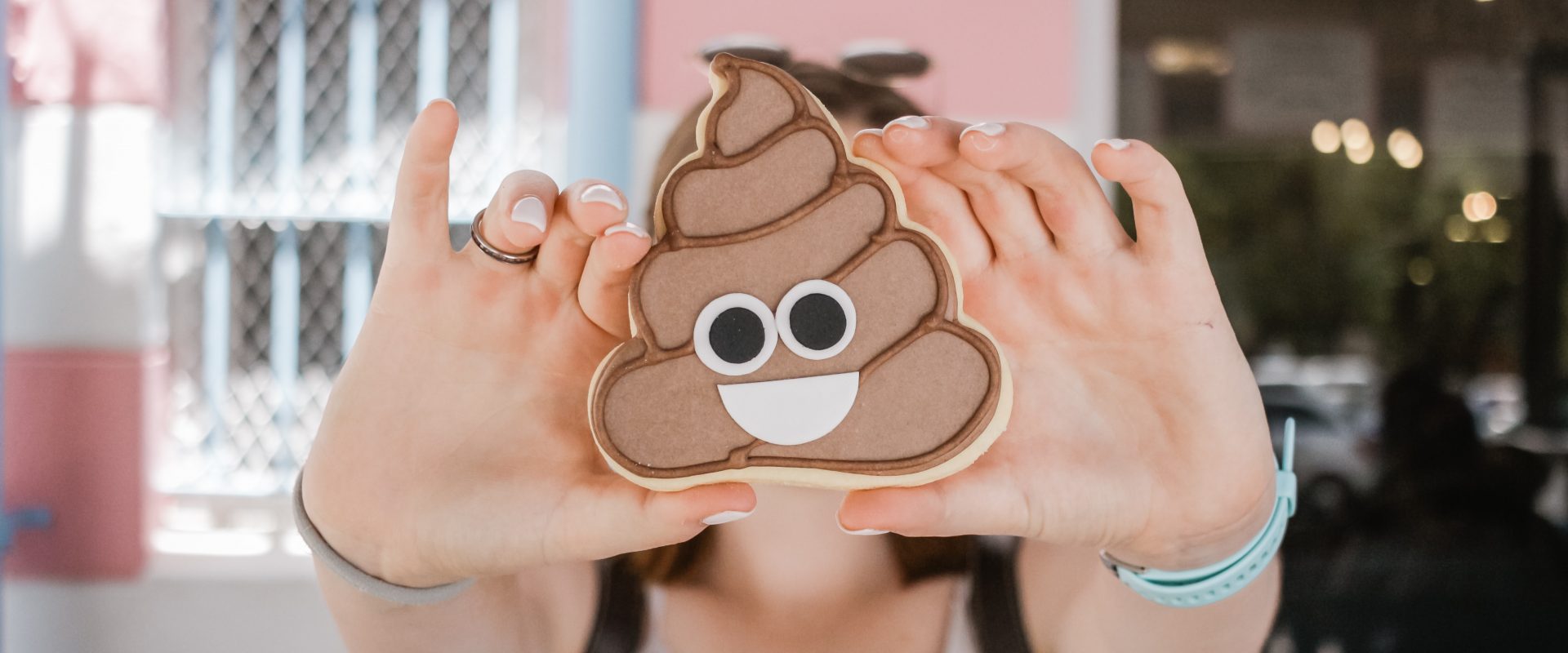 a woman holding a cookie