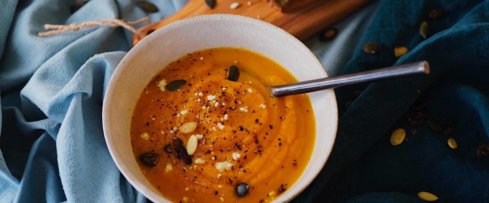 a bowl of soup with nuts and toasted bread