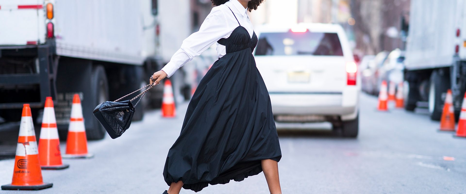 yara shahidi in a dress with a blouse layered underneath