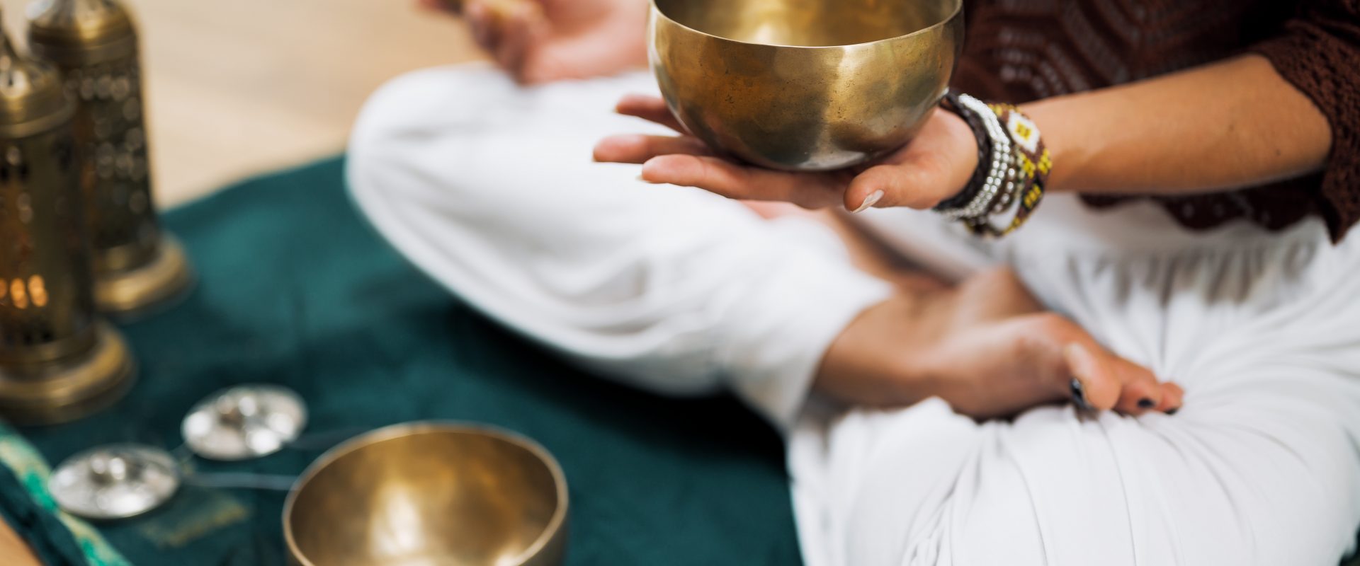 a woma holding a tibetan singing bowl