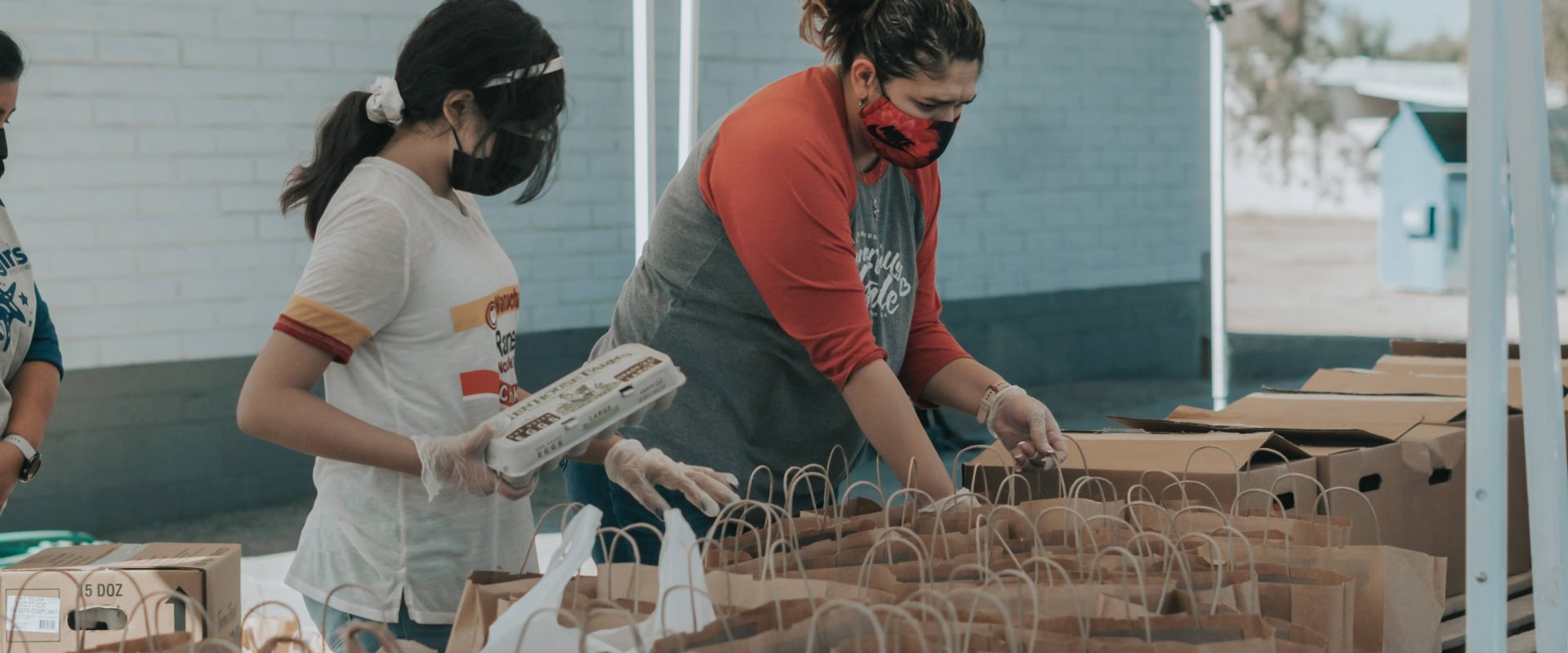 women at a charity drive preparing packages