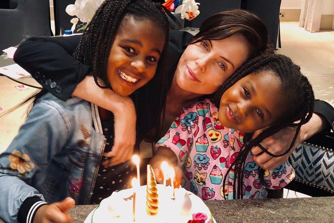 Charlize Theron says she strives to raise her two daughters to be accepting