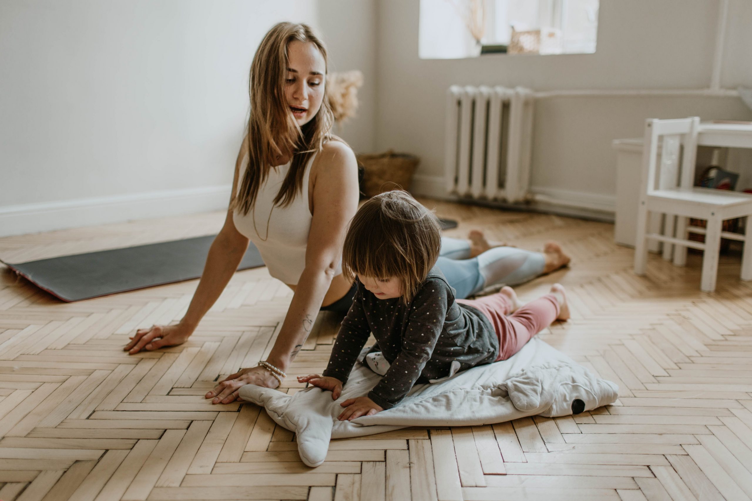 Mom and child stretching for somatic exercises 
