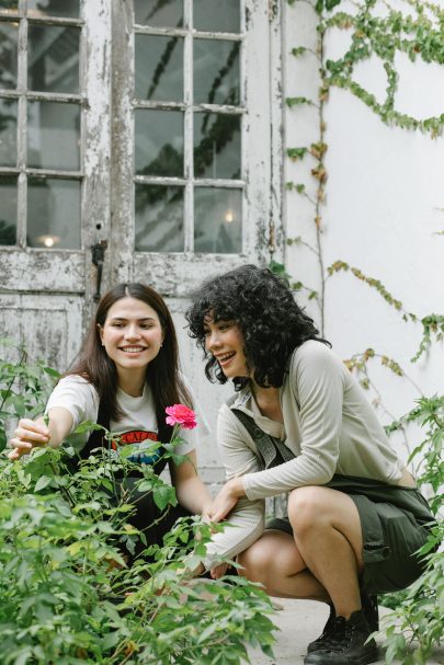 two women looking at rose bush